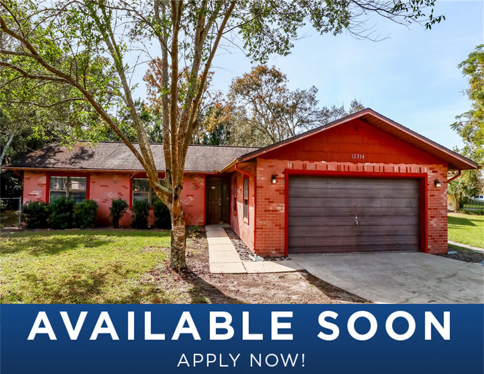 a red brick house with a garage door