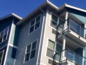 a row of new apartment buildings on a sunny day