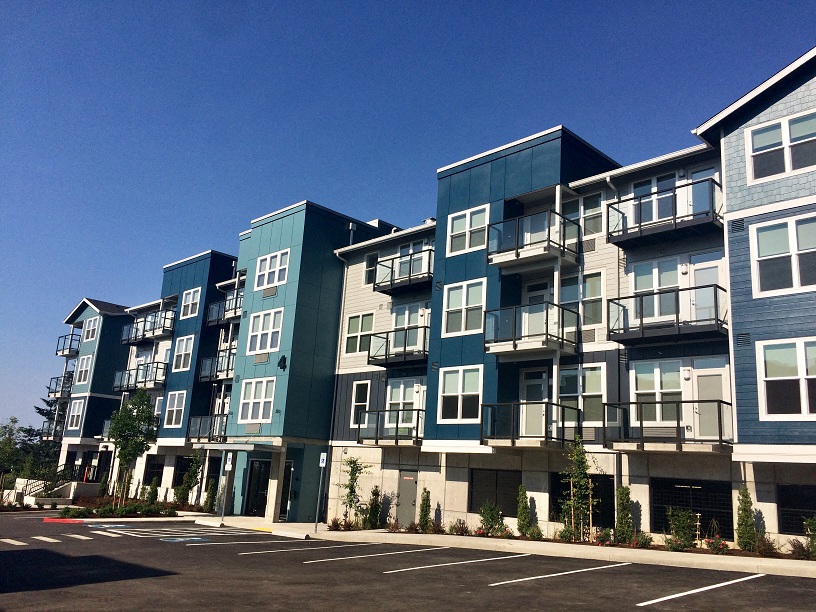 new apartment buildings on the side of a street