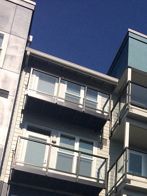 an apartment building with a blue facade and balconies