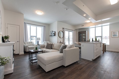 A living room with a white couch and a fireplace.