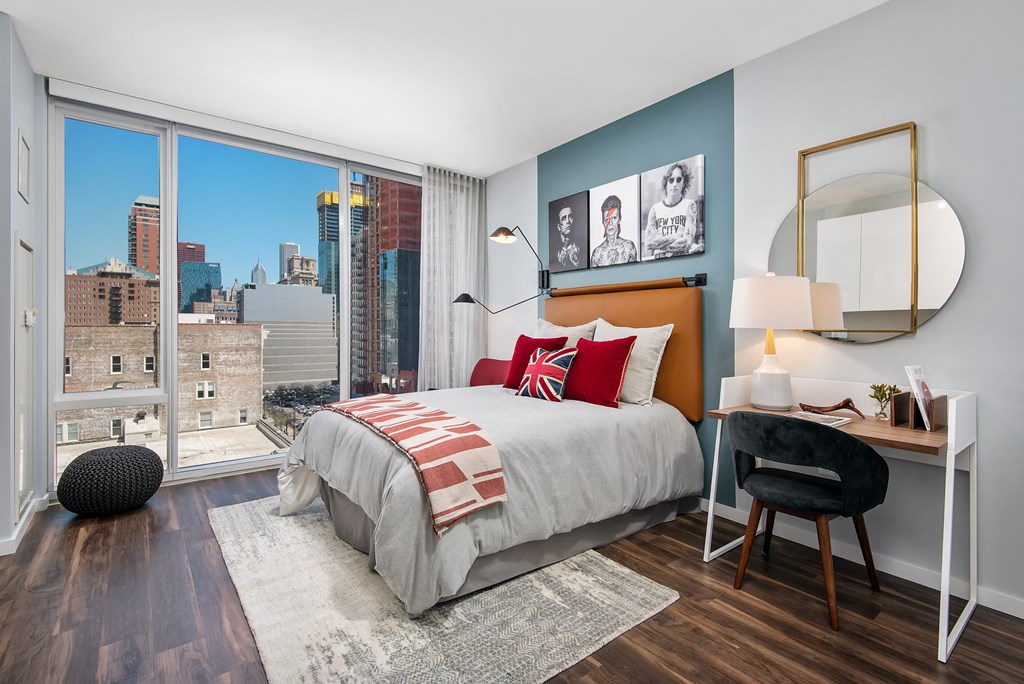 Furnished studio bedroom with floor to ceiling windows at Eleven40, Chicago, IL