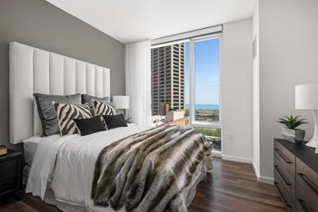 Furnished bedroom with floor to ceiling windows Furnished bedroom with floor to ceiling windows at Eleven40, Chicago - Photo Gallery 4