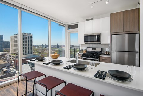a kitchen with a large counter and a view of the city