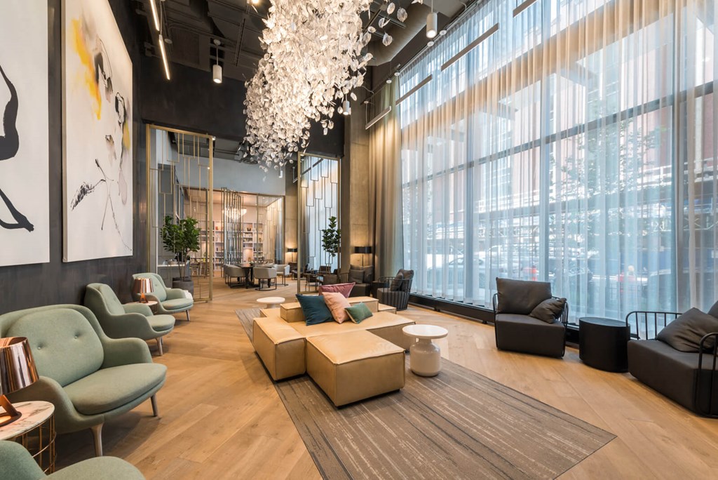 a lobby with couches and chairs and a large window