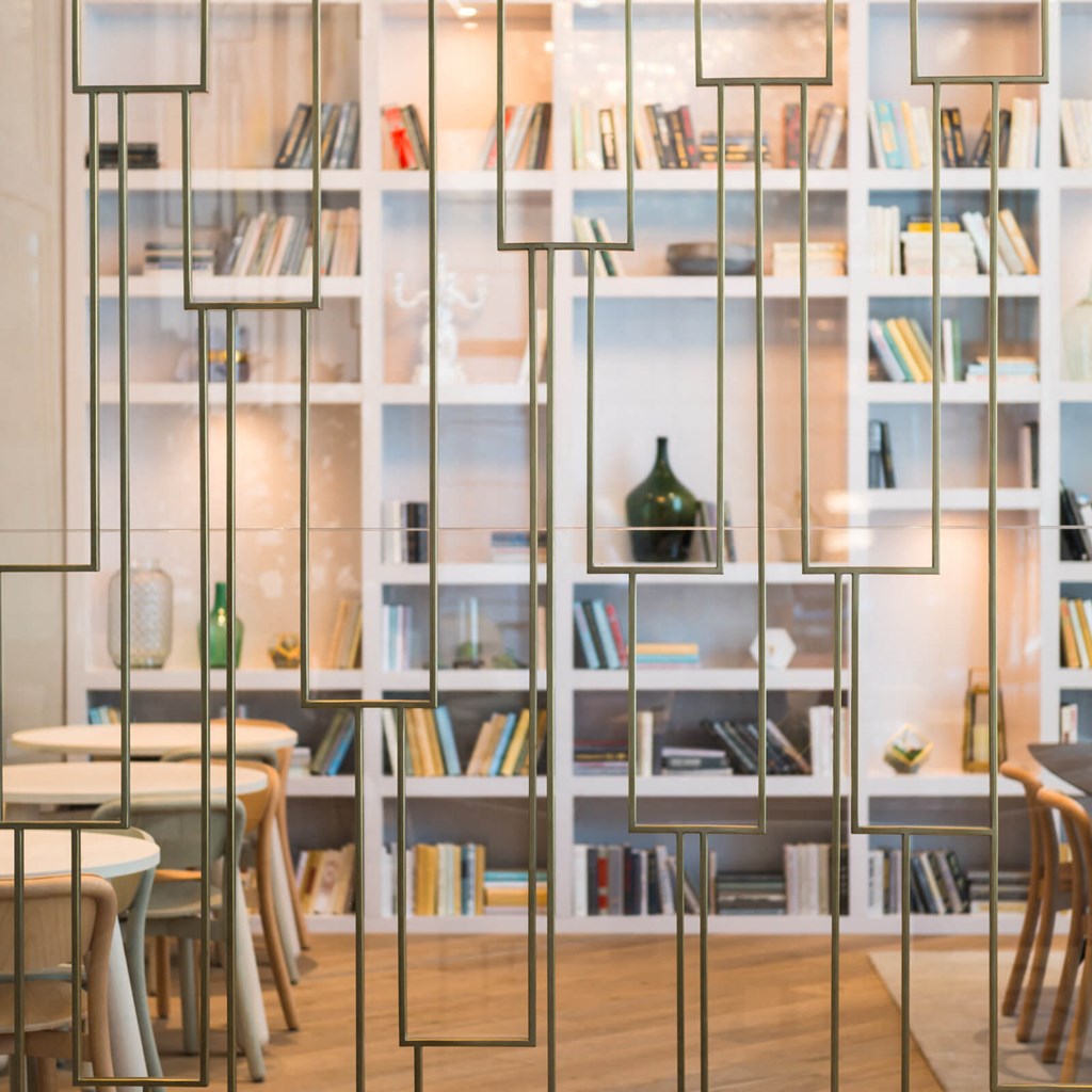 a room with tables and bookshelves and a bookshelf filled with books