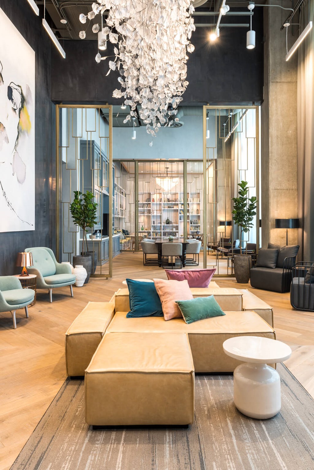 a lobby with couches and chairs and a chandelier