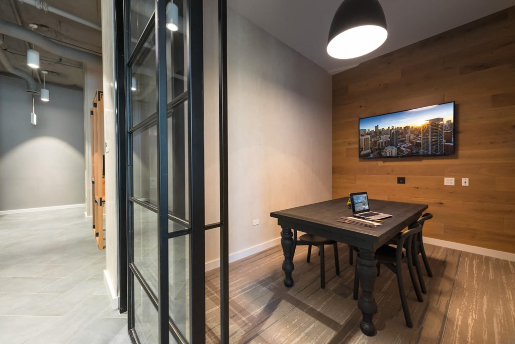 a conference room with a table and a laptop on it