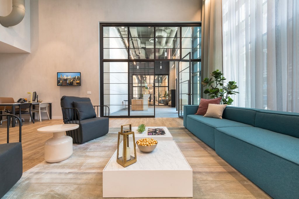 a living room with blue couches and a coffee table
