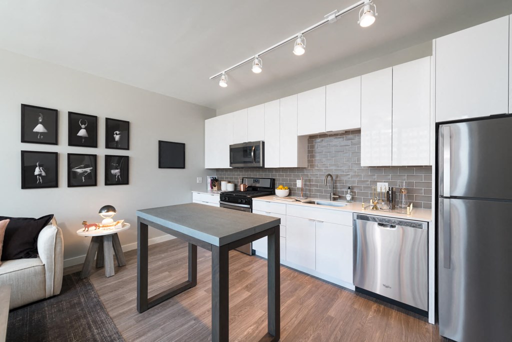 a kitchen with a table and a refrigerator