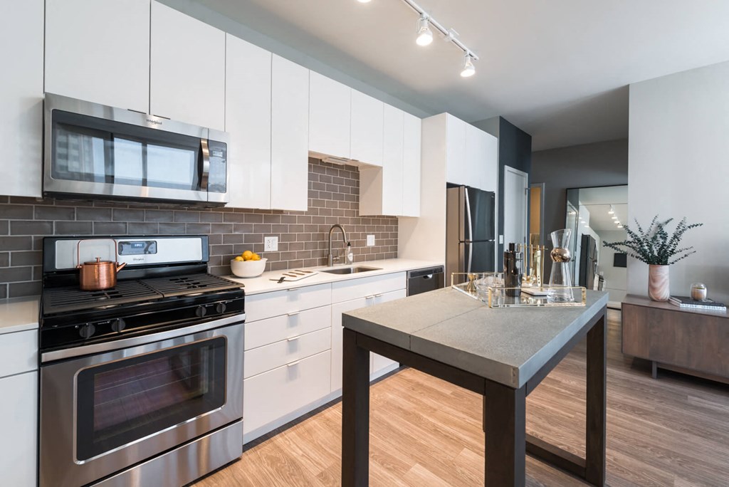 a kitchen with stainless steel appliances and a table