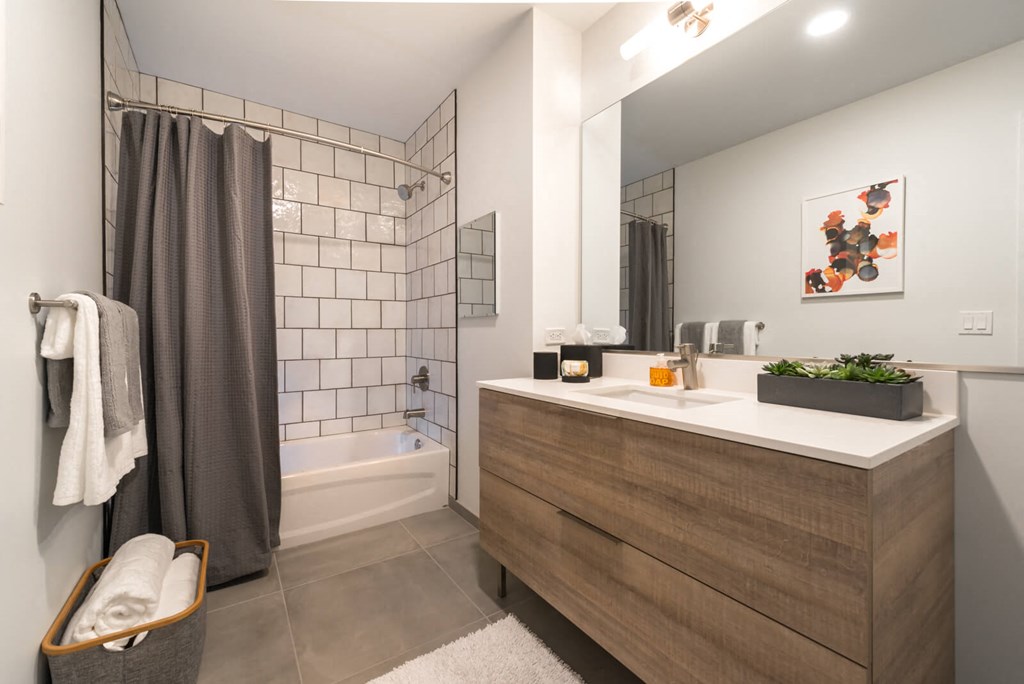 a bathroom with a shower and a sink and a mirror