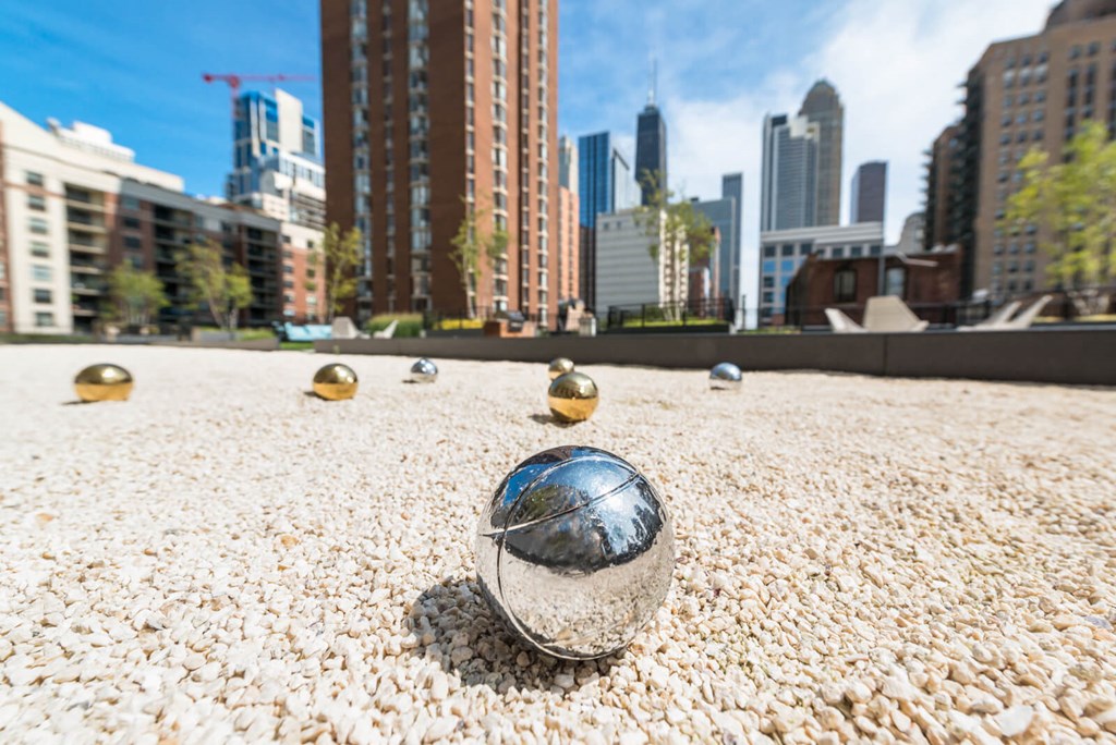 a glass ball on the ground with a city skyline in the background