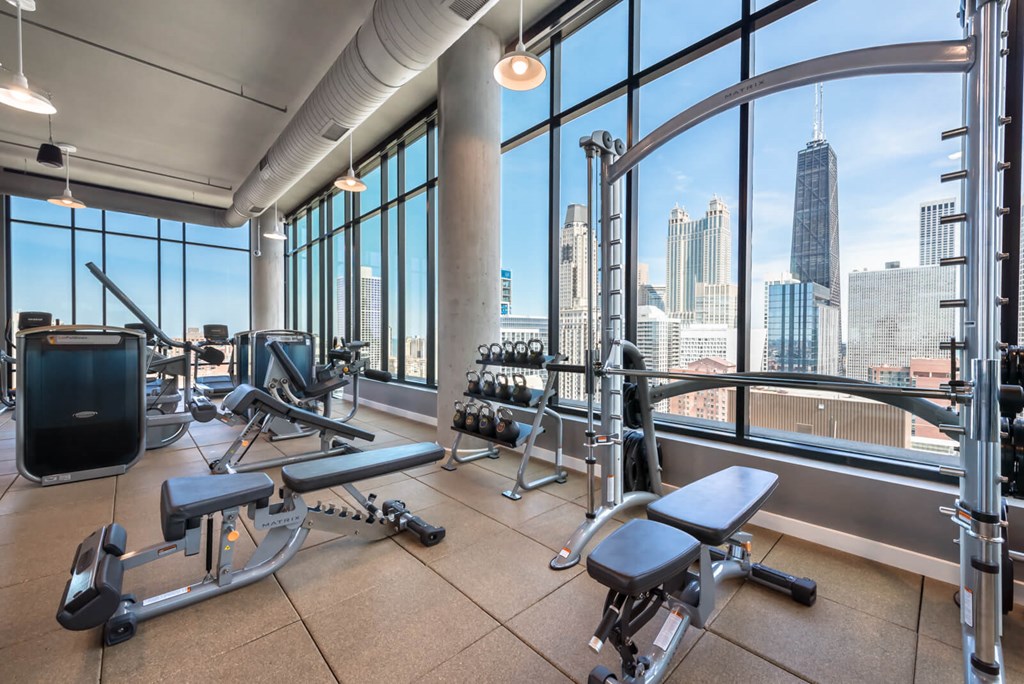 a gym with a view of the city and skyscrapers