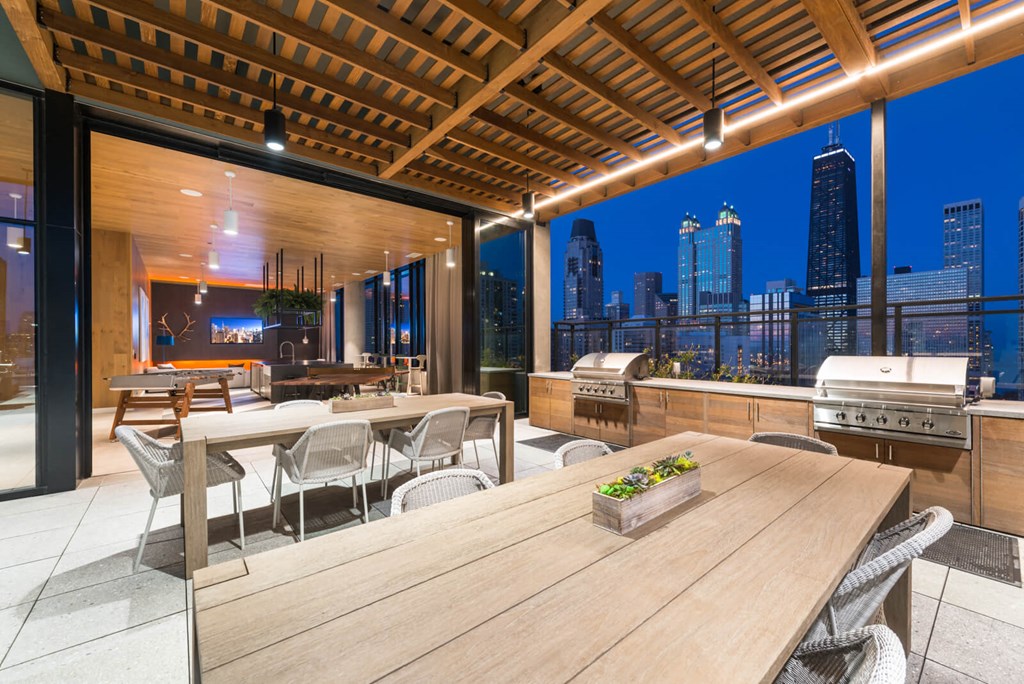 a terrace with a table and chairs and a city skyline