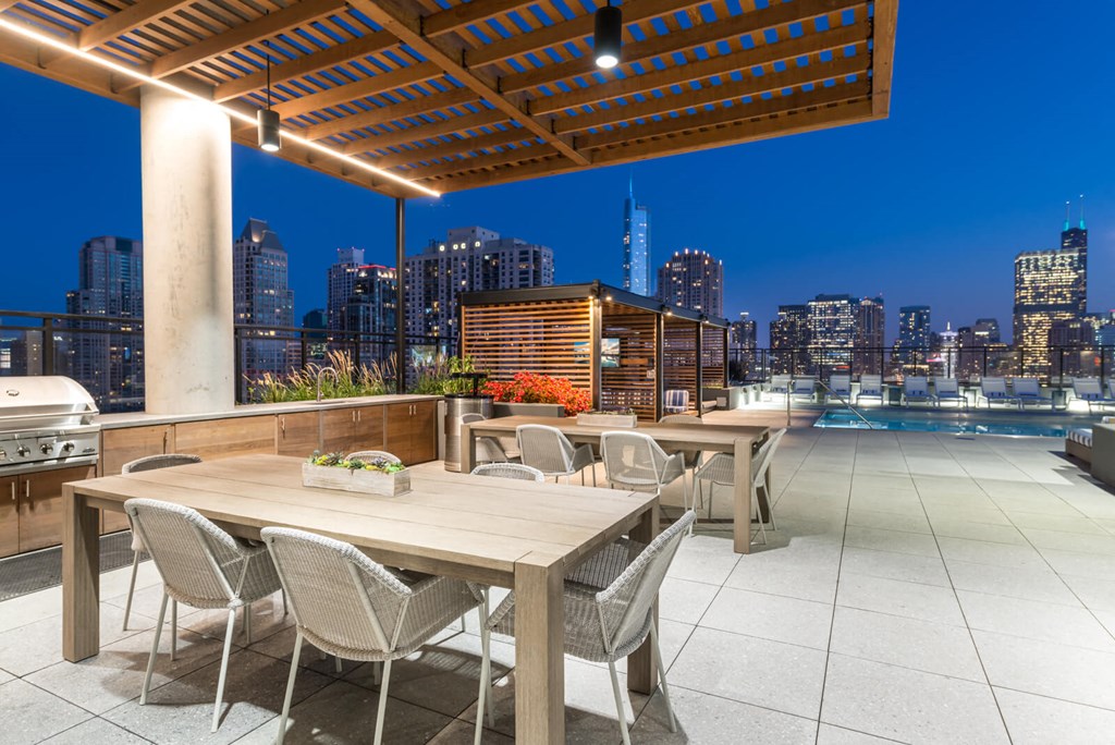 a dining area with a view of the city at night