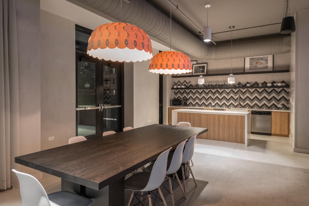 a dining room with a long wooden table and chairs