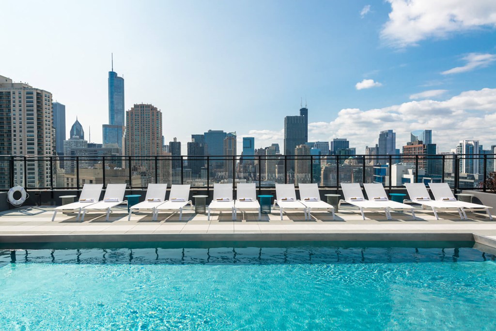 a pool with a city skyline in the background