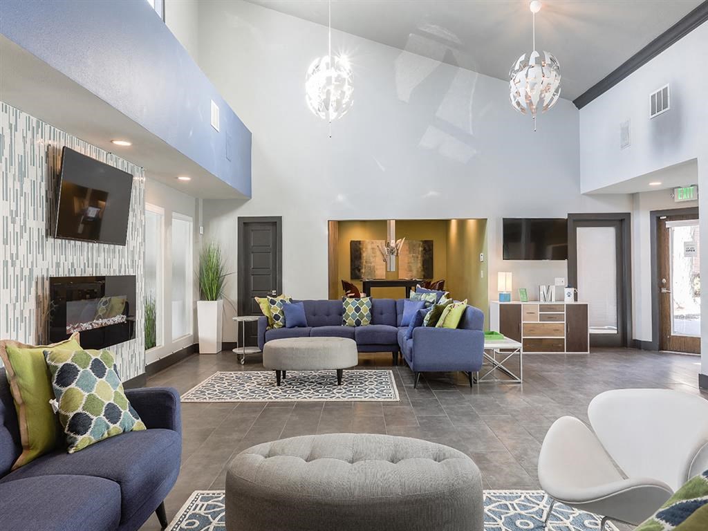 a living room with couches and chairs and a fireplace