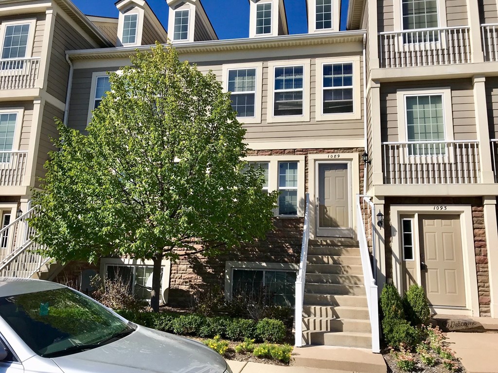 a car parked in front of an apartment building