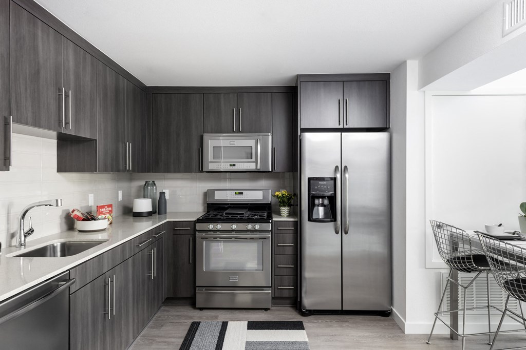 a kitchen with stainless steel appliances and a stainless steel refrigerator