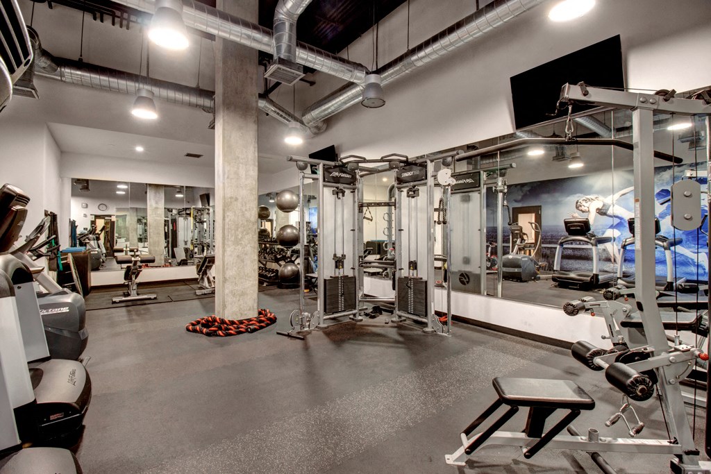 a gym with weights machines and other gym equipment
