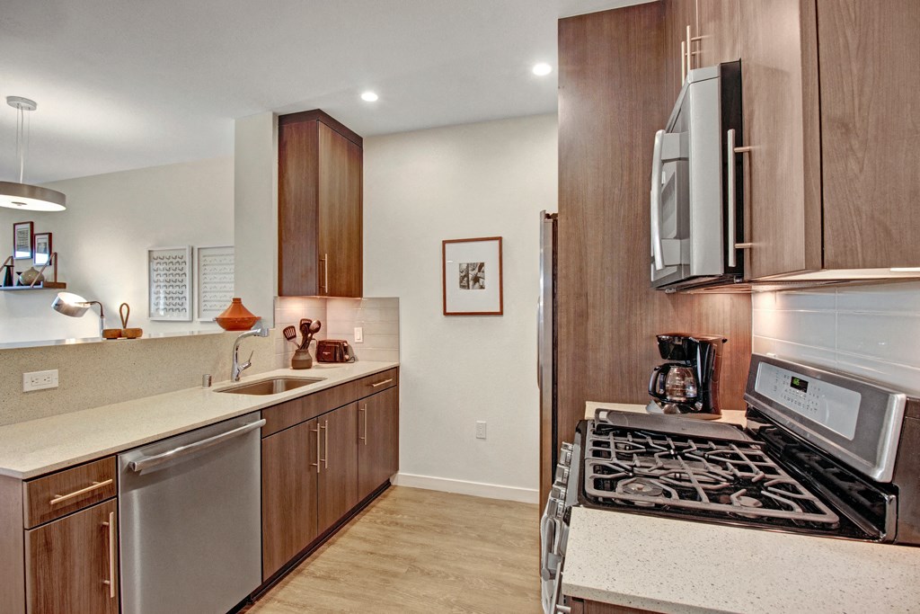a kitchen with a stove and a sink and a microwave