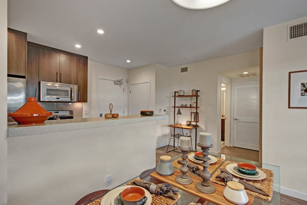 a kitchen and dining room with a table with dishes on it