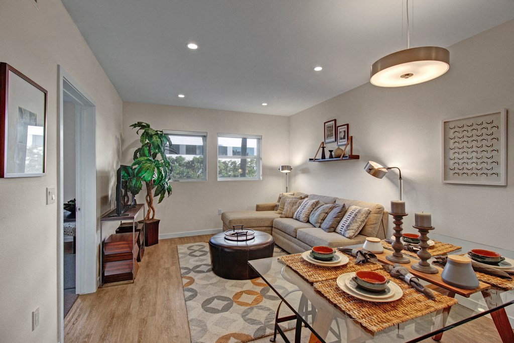 a living room and dining room with a table and chairs