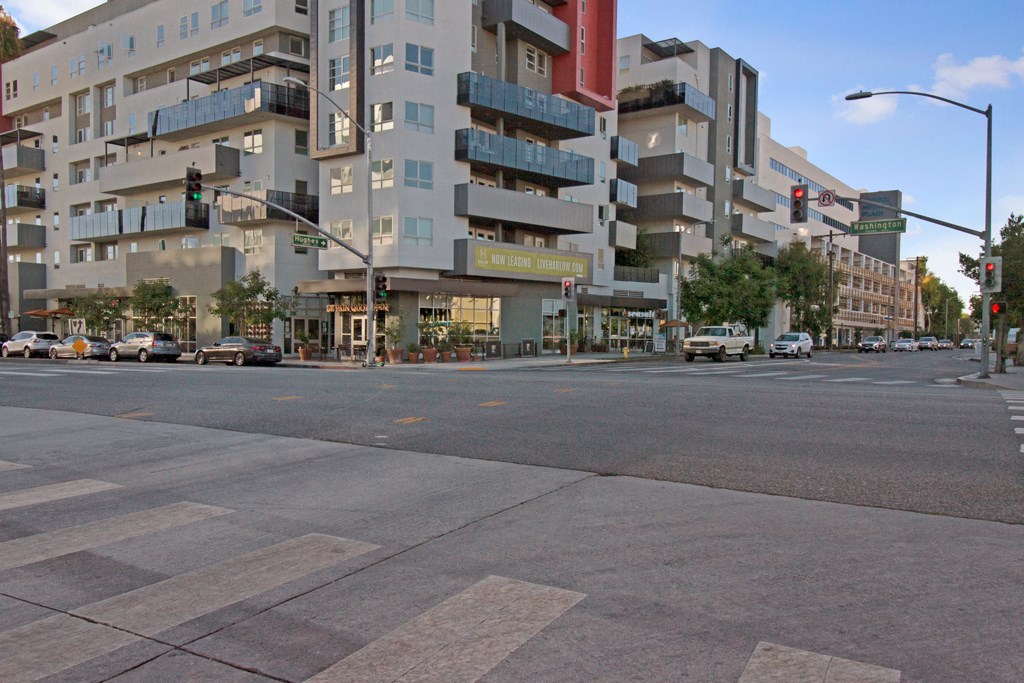 an empty street in front of a large building at an intersection