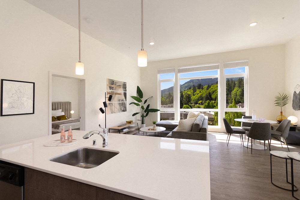 the view from the kitchen of an open living room and dining room in a house