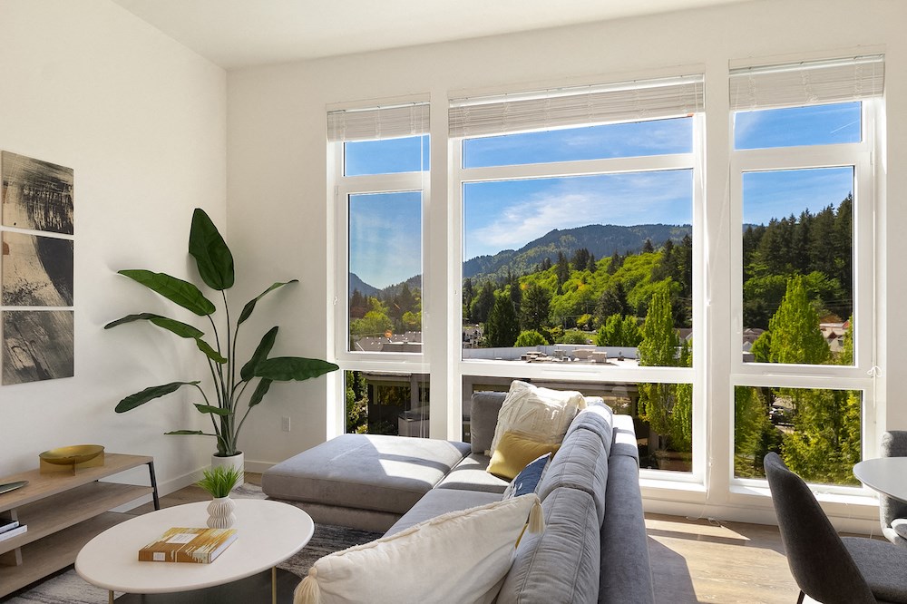 a living room with a couch and a view of a mountain