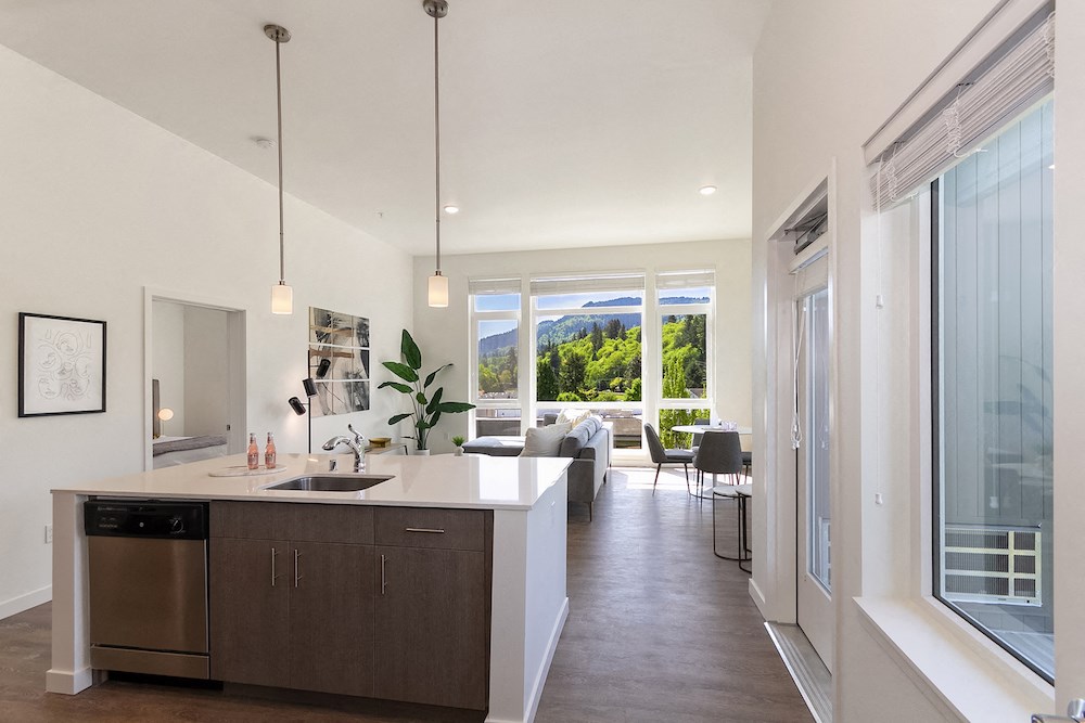 the view from the kitchen into the living room of a new home