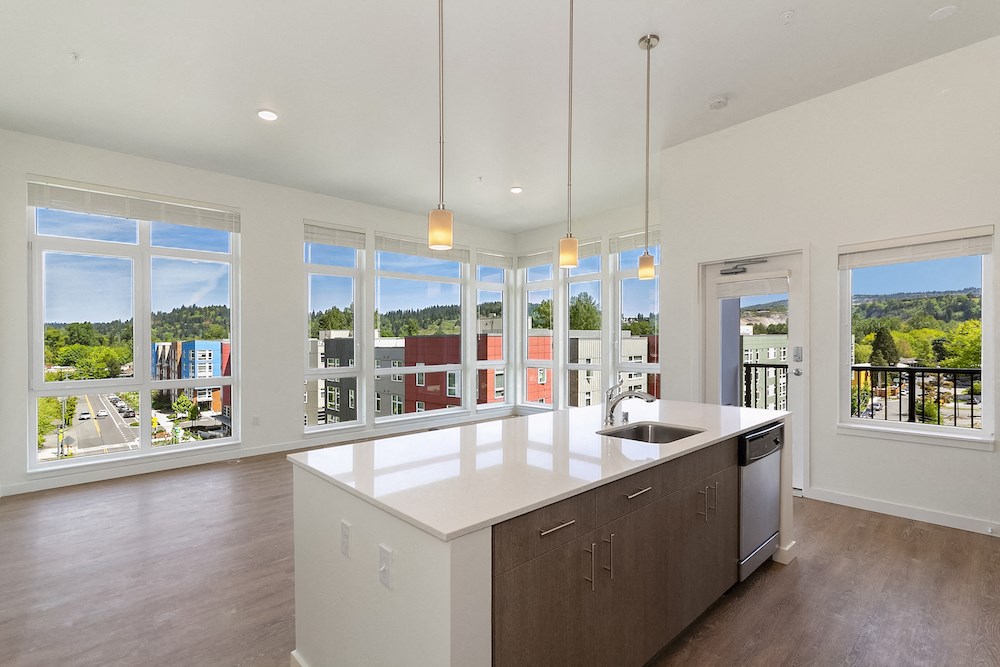 a large kitchen with a large island and many windows