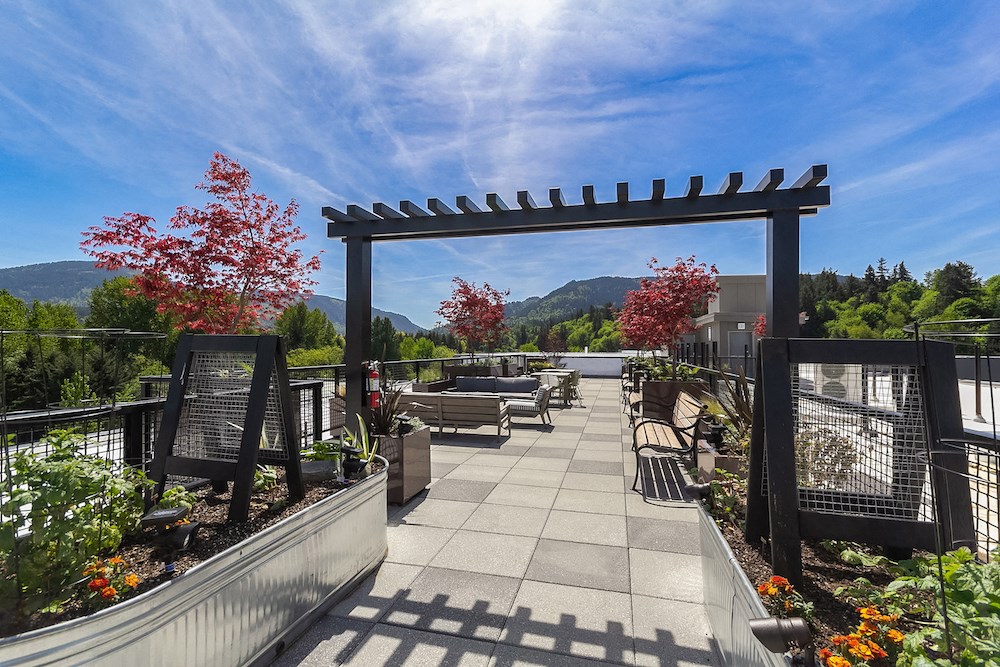 a patio with a view of the mountains and a blue sky