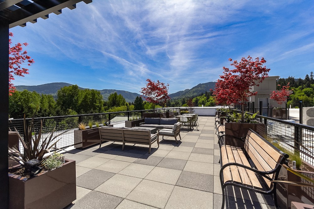 the deck on the top of the building has benches and tables