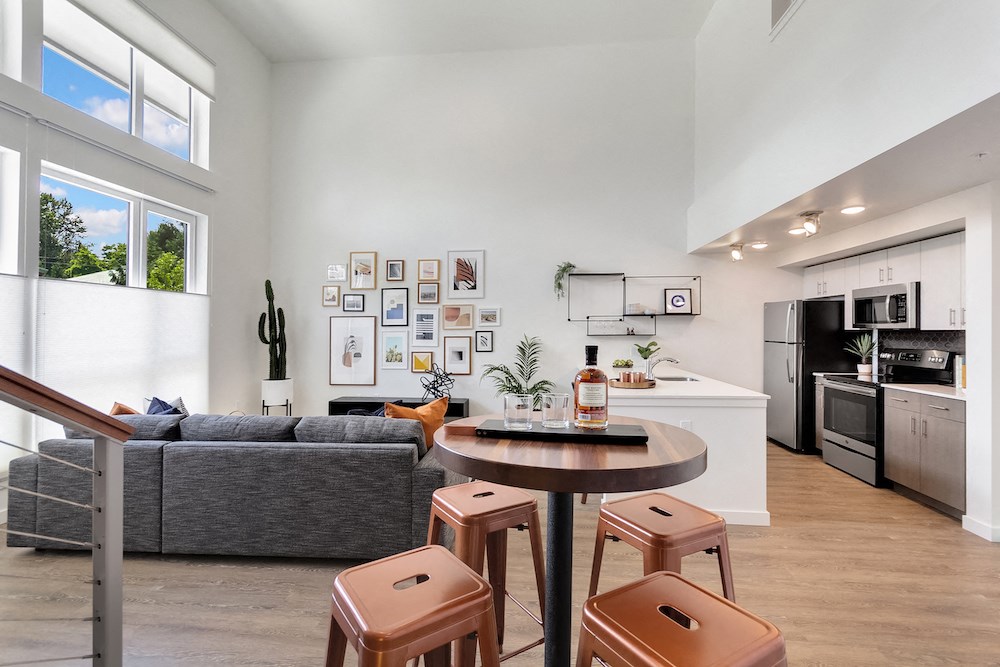 a living area with a kitchen and a dining table