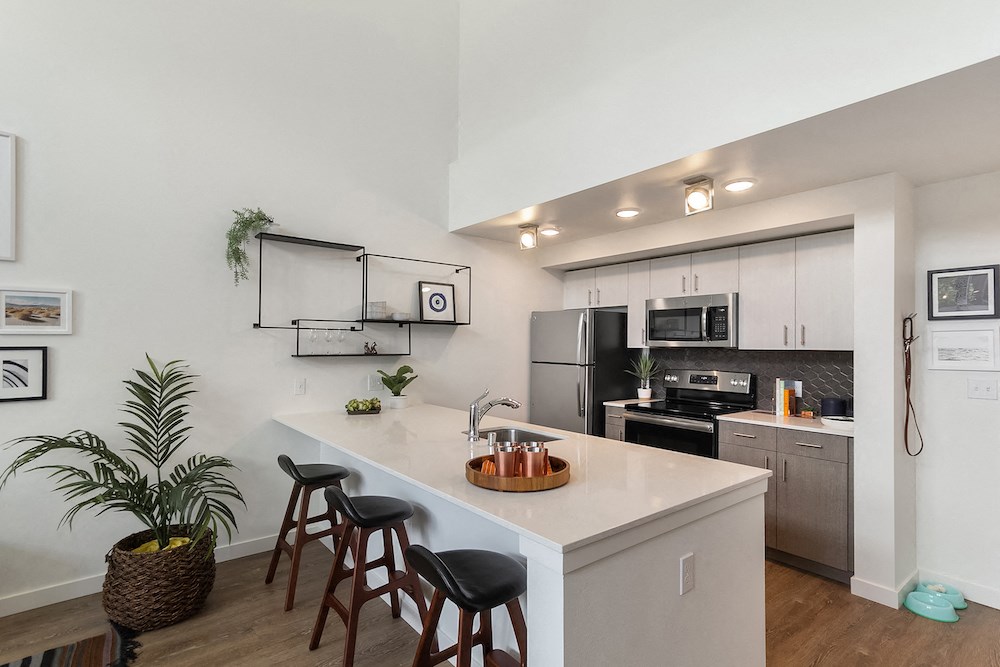 a kitchen with a large island with bar stools
