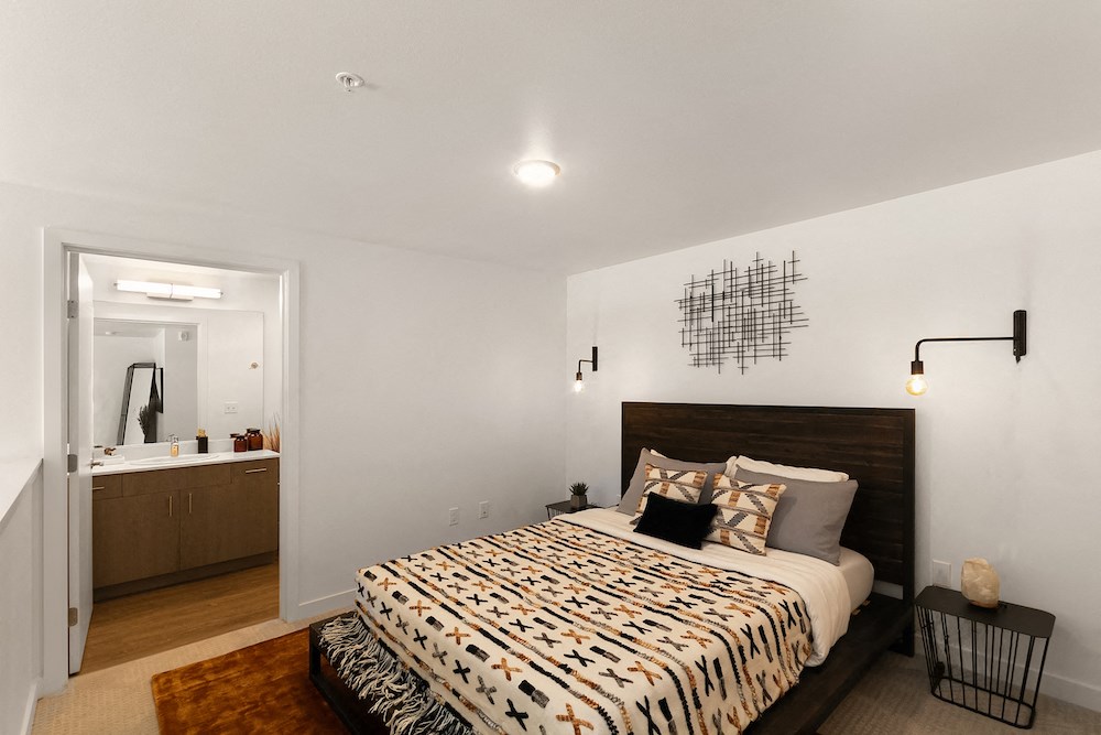 a bedroom with a bed and a bathroom