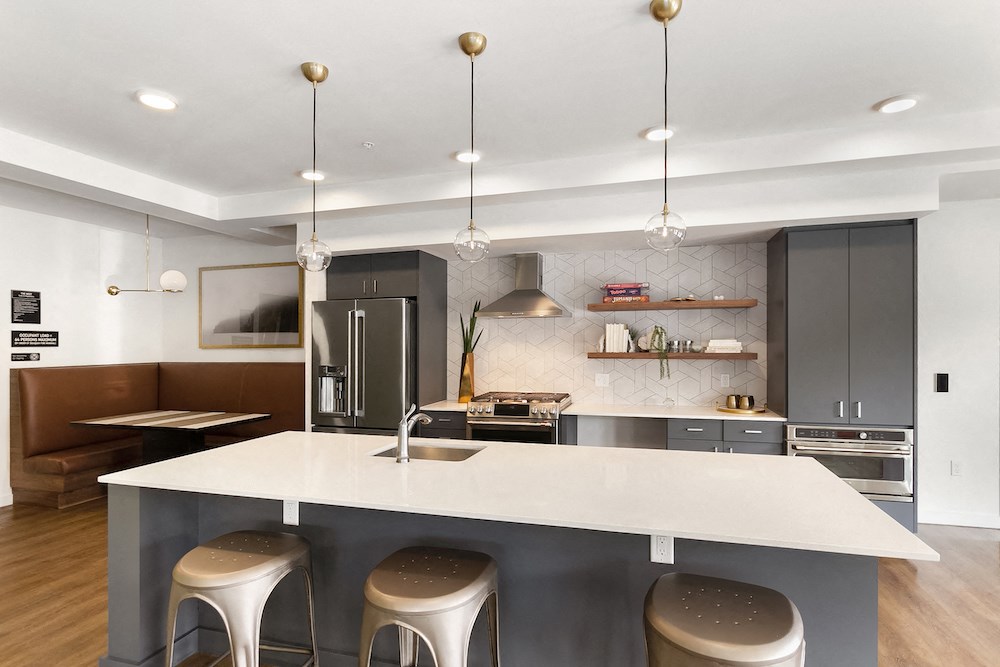 a kitchen with an island and three stools