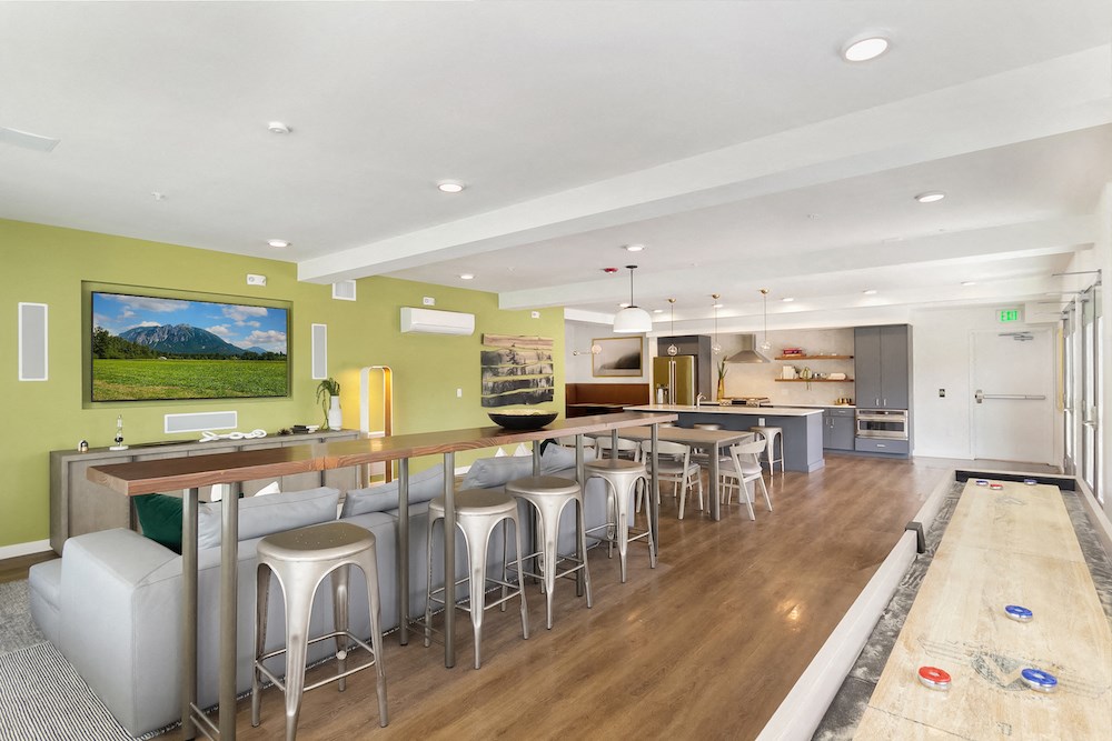 a living room with a bar and a kitchen