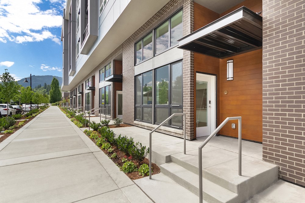 of a building with stairs and a sidewalk