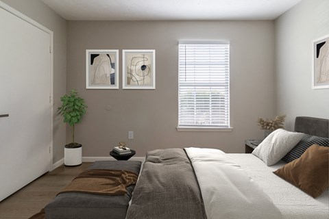 A bedroom with a large bed and two framed artworks on the wall.