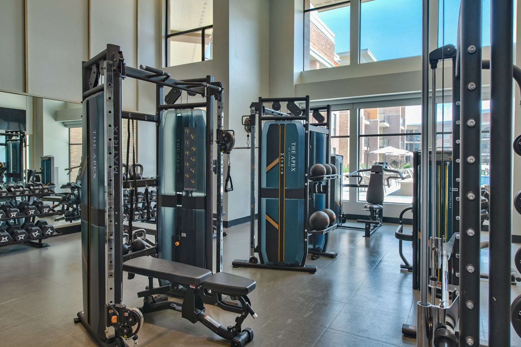 indoor gym with free weights, benches, and cable machines at The Apex at CityPlace, Overland Park