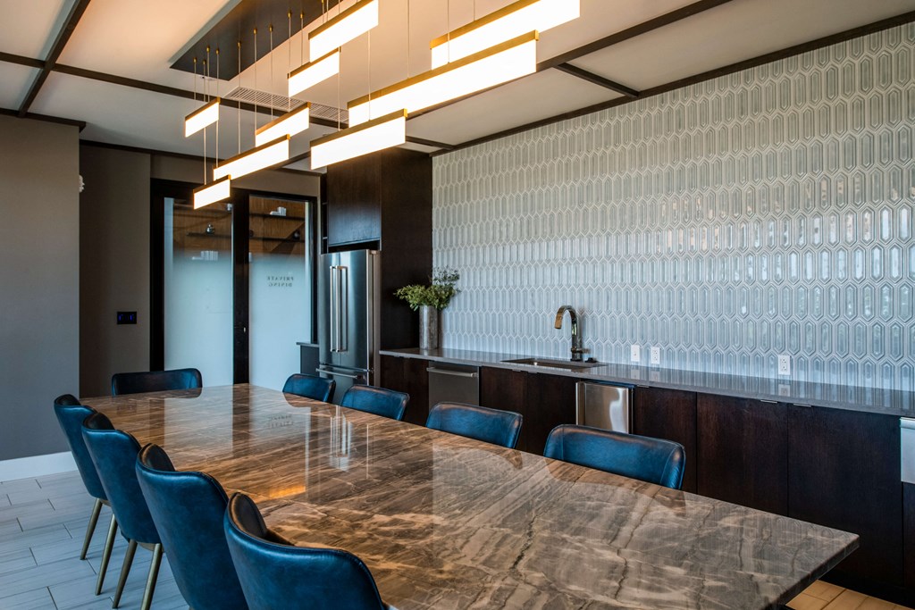 conference room with large table and blue chairs and a countertop with a sink behind it at The Apex at CityPlace, Overland Park, Kansas