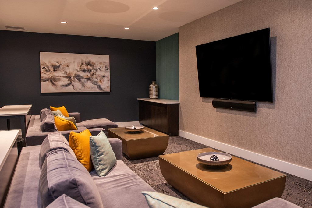 lounge area with mounted tv and couches around tables at The Apex at CityPlace, Kansas, 66210