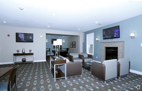 A living room with a fireplace and a television on the wall.