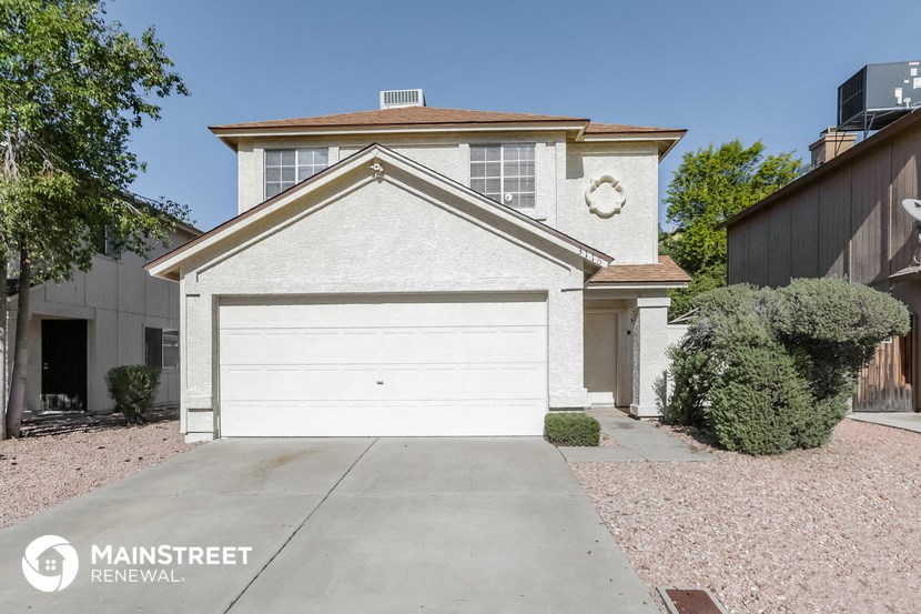 a white house with a white garage door