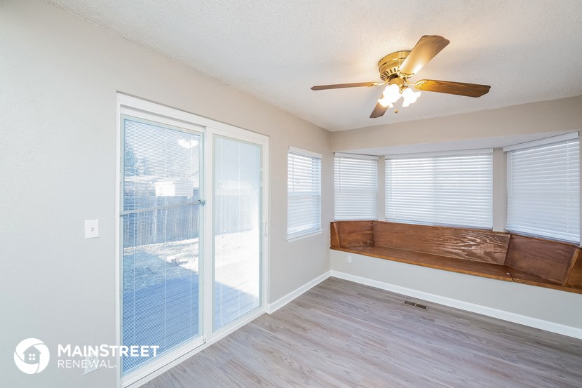 a living room with a couch and a ceiling fan