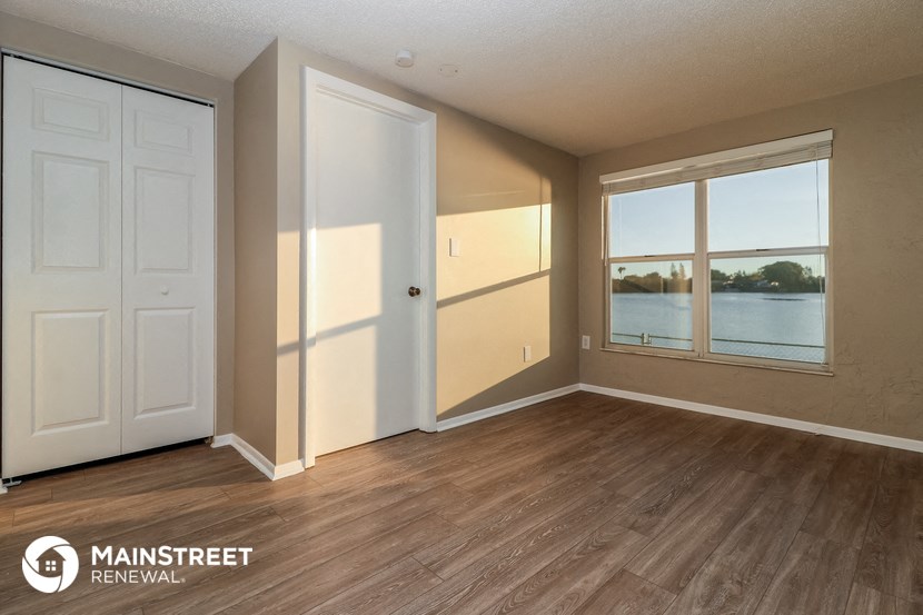 the living room of an apartment with a view of the water